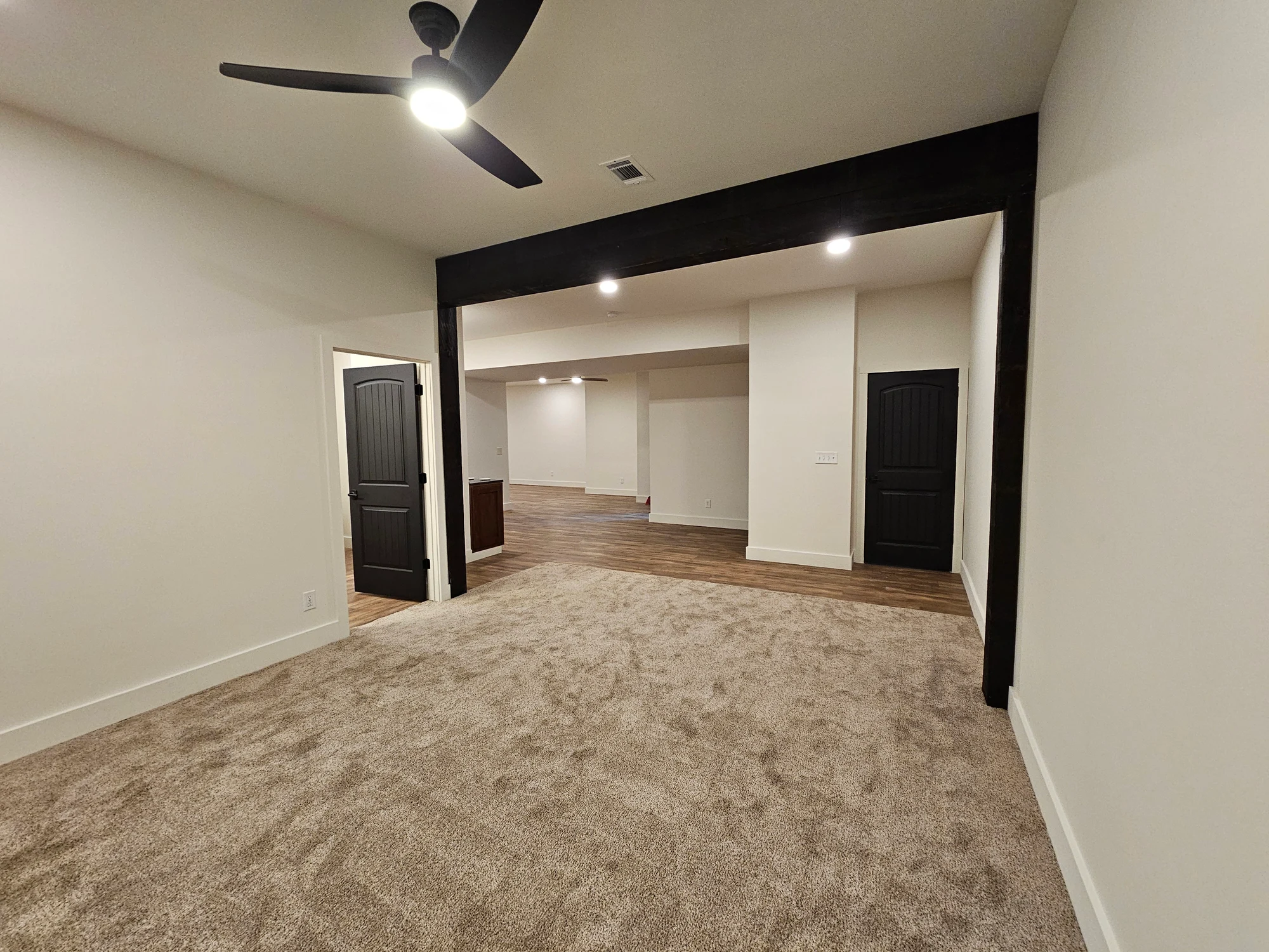 Completed lower-level rooms viewed from the adjoining space